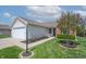 Inviting home exterior with lush green lawn and a blooming tree in the front yard at 7652 Wood Stream Dr, Indianapolis, IN 46239