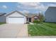 Charming single-story home with a well-manicured lawn and attached two-car garage at 7652 Wood Stream Dr, Indianapolis, IN 46239