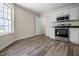 Well-lit kitchen with white cabinets, stainless appliances, and modern flooring at 7652 Wood Stream Dr, Indianapolis, IN 46239