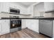 Bright kitchen featuring stainless steel appliances, white cabinetry, and dark countertops at 7652 Wood Stream Dr, Indianapolis, IN 46239