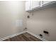 Functional laundry room with wooden floors, white cabinets and plenty of room for appliances and storage at 7652 Wood Stream Dr, Indianapolis, IN 46239