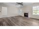 Spacious living room with a fireplace, ceiling fan and a back door providing natural light at 7652 Wood Stream Dr, Indianapolis, IN 46239