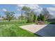 Outdoor patio with table and chairs overlooks the well-maintained lawn and pond at 7652 Wood Stream Dr, Indianapolis, IN 46239