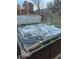 Hot tub with cover open surrounded by green trees and grass at 769 Raintree Dr, Avon, IN 46123