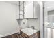 Farmhouse style laundry room complete with industrial-style shelving and sink at 769 Raintree Dr, Avon, IN 46123