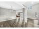 Bright living room with dark floors, high ceilings, many windows and chandelier at 769 Raintree Dr, Avon, IN 46123