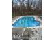 In-ground pool with blue water surrounded by concrete and fence at 769 Raintree Dr, Avon, IN 46123