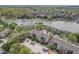 Aerial view of a residential area with waterfront condo residences, boat docks, parking, and mature trees at 8140 Shorewalk Dr # C, Indianapolis, IN 46236
