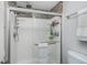 Bathroom shower with glass doors, a shower head, and tile accents at 8140 Shorewalk Dr # C, Indianapolis, IN 46236