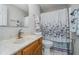 Neutral bathroom featuring tile floors, marble vanity and a shower-tub combo with a floral shower curtain at 8140 Shorewalk Dr # C, Indianapolis, IN 46236