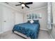 Bedroom featuring a ceiling fan, artwork, a window, and a closet at 8140 Shorewalk Dr # C, Indianapolis, IN 46236