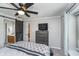 Comfortable bedroom with carpet, a barn door to the bathroom, and a dresser with a television on top at 8140 Shorewalk Dr # C, Indianapolis, IN 46236