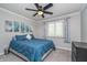 Inviting bedroom featuring artwork, a ceiling fan, a window, and a blue comforter on the bed at 8140 Shorewalk Dr # C, Indianapolis, IN 46236