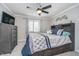 Bedroom featuring a ceiling fan, a window, and a gray dresser and bedframe at 8140 Shorewalk Dr # C, Indianapolis, IN 46236