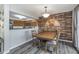 Dining room featuring a unique accent wall, access to the kitchen, and sliding doors to the deck at 8140 Shorewalk Dr # C, Indianapolis, IN 46236
