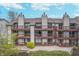 Exterior view of condo units with wooden decks on multiple floors, lawn, and blue sky at 8140 Shorewalk Dr # C, Indianapolis, IN 46236