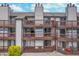 Exterior view of the rear of condo units with wooden decks on multiple floors and a lawn at 8140 Shorewalk Dr # C, Indianapolis, IN 46236