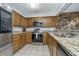 Bright kitchen with granite countertops, stainless steel appliances, and stone accent wall at 8140 Shorewalk Dr # C, Indianapolis, IN 46236