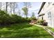 Expansive backyard with lush green grass and a deck offering outdoor living and a serene view at 8242 Windhaven Cir, Indianapolis, IN 46236