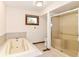 Bright bathroom featuring a soaking tub and glass-enclosed shower at 8242 Windhaven Cir, Indianapolis, IN 46236