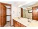Bathroom with a dual sink vanity and a large mirror at 8242 Windhaven Cir, Indianapolis, IN 46236