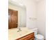 Bathroom with a cream sink top, modern faucet, and wooden cabinets at 8242 Windhaven Cir, Indianapolis, IN 46236