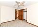 Bedroom with neutral carpet, wooden trim, a ceiling fan, and closet at 8242 Windhaven Cir, Indianapolis, IN 46236