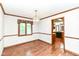 Inviting dining room with hardwood floors, chandelier, and a window with decorative valance at 8242 Windhaven Cir, Indianapolis, IN 46236