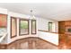 Bright dining room with hardwood floors, chandelier, large windows, and view into adjoining kitchen at 8242 Windhaven Cir, Indianapolis, IN 46236