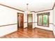 Inviting dining room featuring hardwood floors, a window, chandelier, and doorway to a view of other rooms at 8242 Windhaven Cir, Indianapolis, IN 46236