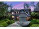 Charming two-story home with a well-manicured lawn and attached two car garage, set against a twilight sky at 8242 Windhaven Cir, Indianapolis, IN 46236