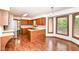 Eat-in kitchen with wood cabinets, stainless steel appliances, and hardwood floors at 8242 Windhaven Cir, Indianapolis, IN 46236