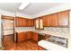 Functional kitchen with wooden cabinets, a tiled backsplash, and stainless steel appliances at 8242 Windhaven Cir, Indianapolis, IN 46236