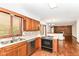 Functional kitchen with wooden cabinets, a tiled backsplash, and stainless steel appliances at 8242 Windhaven Cir, Indianapolis, IN 46236