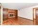 Living room featuring a brick fireplace, built-in bookshelves, and wood floors at 8242 Windhaven Cir, Indianapolis, IN 46236