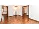Spacious living room featuring hardwood floors, a modern lamp, and doorways leading to other rooms in the home at 8242 Windhaven Cir, Indianapolis, IN 46236