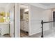 Bright bathroom with a white vanity, decorative mirror, and modern finishes at 8277 Plumwood Ln, Indianapolis, IN 46256