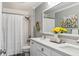 Bathroom featuring double sinks, quartz counters, white cabinets, and modern fixtures at 8277 Plumwood Ln, Indianapolis, IN 46256