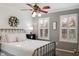 Sunlit bedroom with ceiling fan, neutral walls, and an inviting queen-sized bed at 8277 Plumwood Ln, Indianapolis, IN 46256