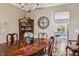Formal dining room with a wooden table, chandelier, and seamless access to the kitchen area at 8277 Plumwood Ln, Indianapolis, IN 46256
