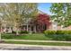 Charming brick home with a lush green lawn, mature trees, and a welcoming front entrance at 8277 Plumwood Ln, Indianapolis, IN 46256