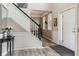 Inviting foyer with a staircase, light wood floors, and decor creating a welcoming entrance at 8277 Plumwood Ln, Indianapolis, IN 46256