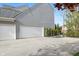 Side view of the home featuring a spacious garage and plenty of parking at 8277 Plumwood Ln, Indianapolis, IN 46256