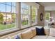 Bright living room with a large window and cozy seating provides backyard views and a relaxing atmosphere at 8277 Plumwood Ln, Indianapolis, IN 46256