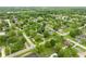 Aerial view of a home in a lush, green neighborhood with a serene lake in the distance at 840 N Indiana St, Mooresville, IN 46158