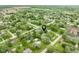 Aerial view of a home in a serene, tree-filled neighborhood with a well-maintained lawn at 840 N Indiana St, Mooresville, IN 46158
