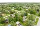 Aerial view of a home nestled among mature trees with a pool and detached garage at 840 N Indiana St, Mooresville, IN 46158