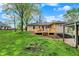 A spacious backyard featuring a patio, new deck, and detached garage, ideal for outdoor activities and storage at 840 N Indiana St, Mooresville, IN 46158