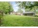 Expansive backyard featuring a deck and large detached building, perfect for outdoor activities and storage at 840 N Indiana St, Mooresville, IN 46158