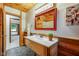 Stylish bathroom with wood paneled walls and a neutral colored vanity at 840 N Indiana St, Mooresville, IN 46158